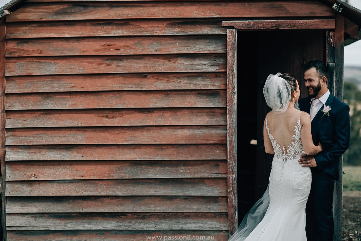 bride and groom in barn